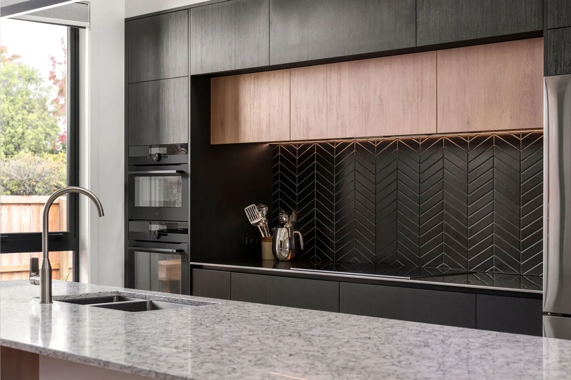 A kitchen with black cabinets and a white counter top.