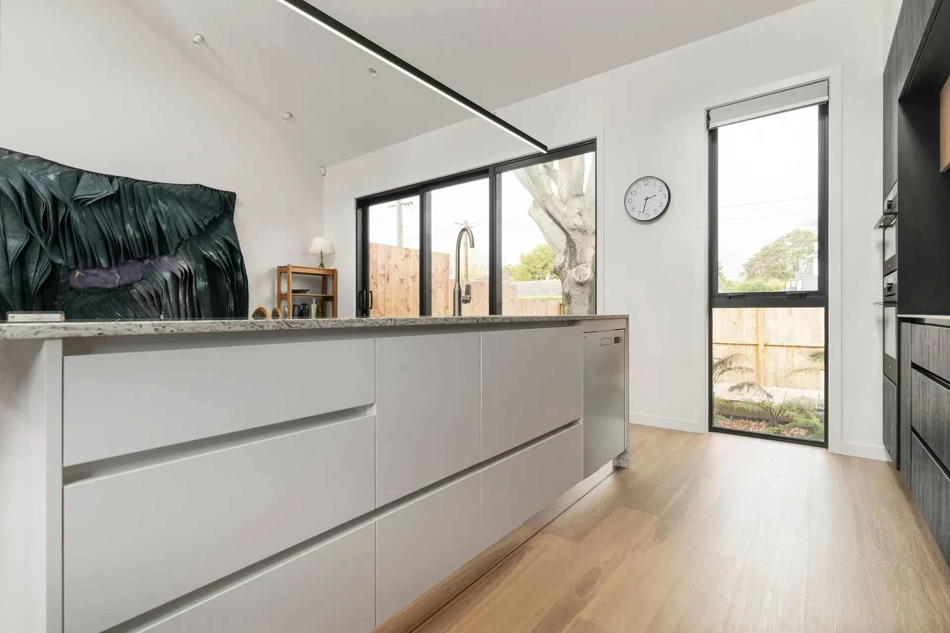 A kitchen with a large island in the middle of it and a lot of windows.