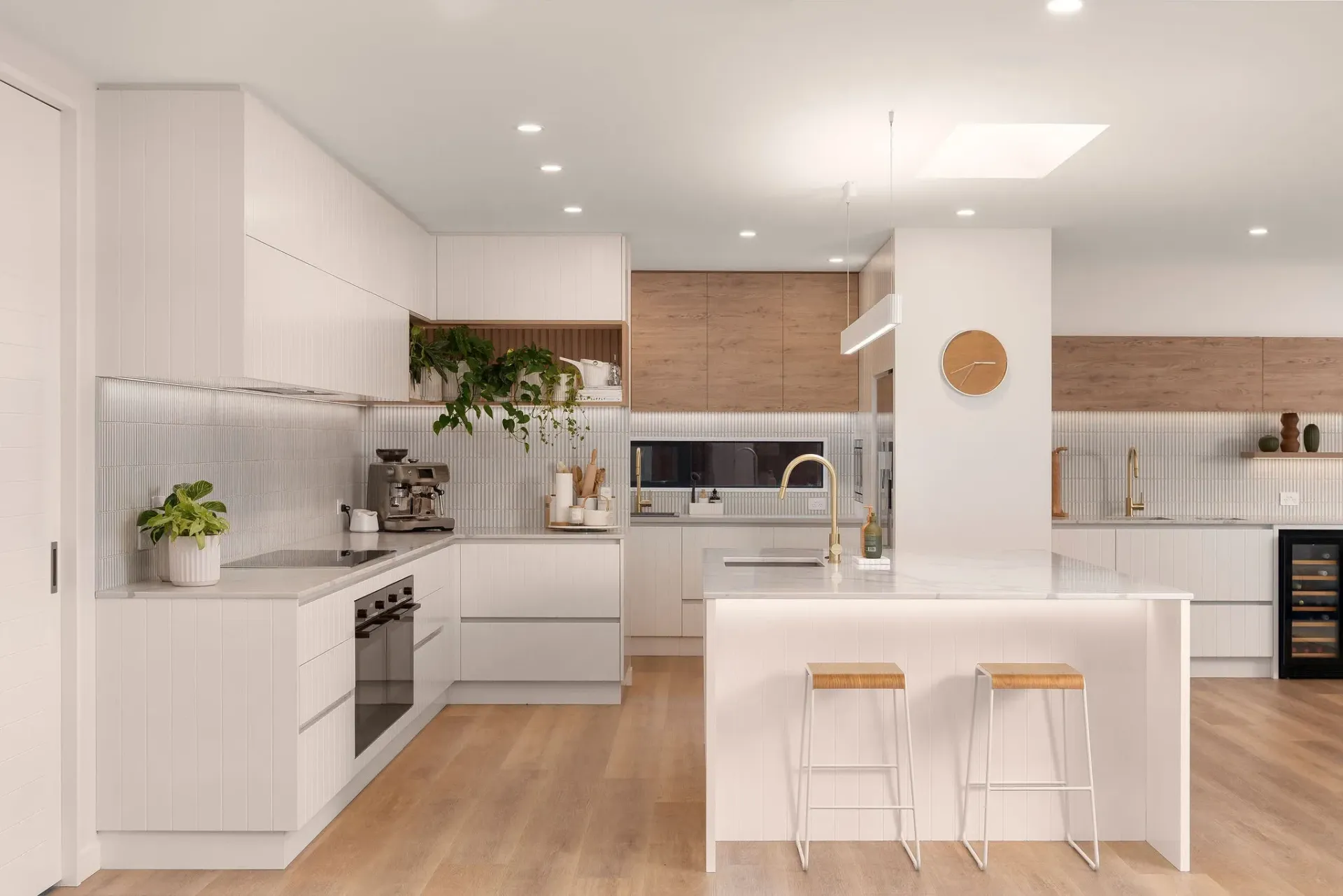 An artist 's impression of a kitchen with white cabinets and wooden floors.