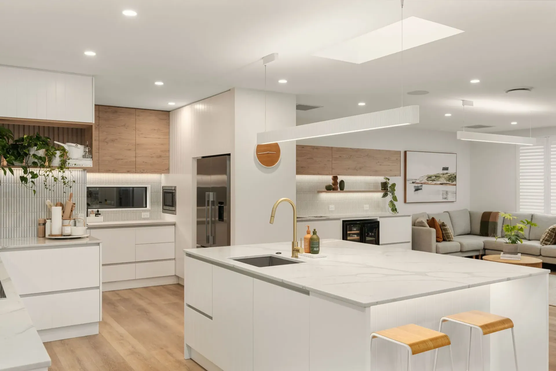 A kitchen with white cabinets and a large island in the middle of the room.