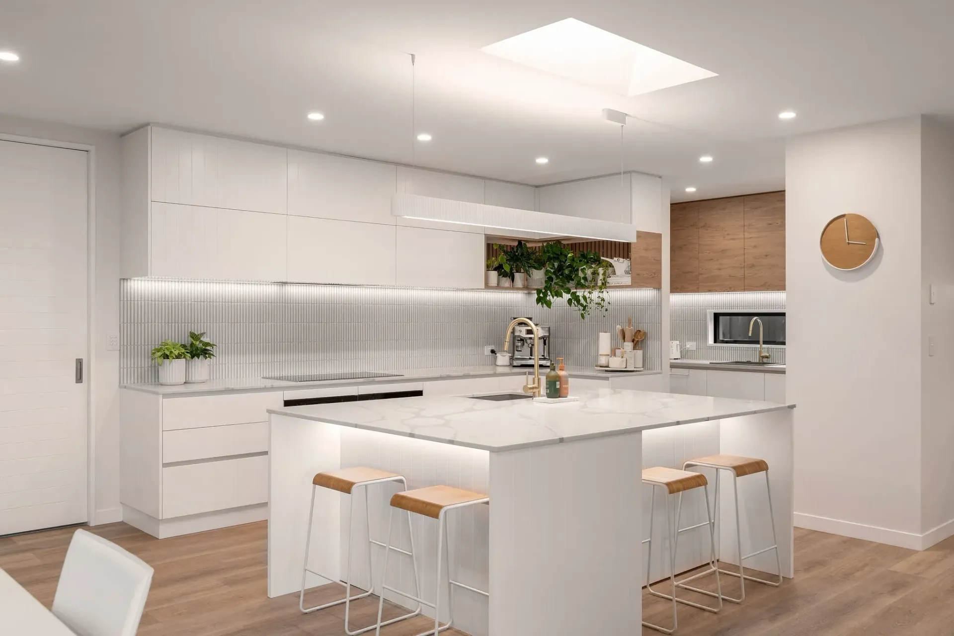An artist 's impression of a kitchen with white cabinets and a large island.