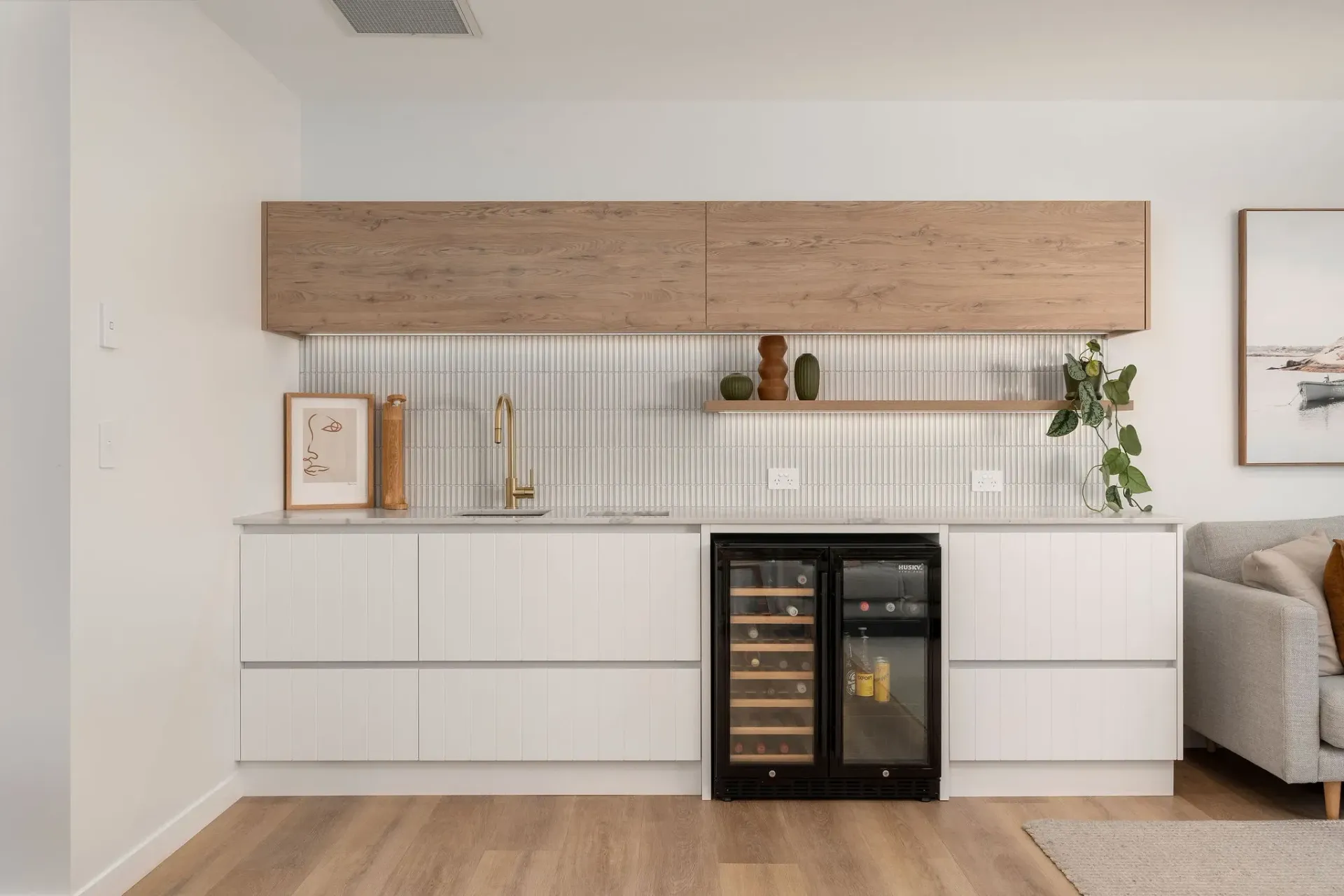 There is a wine cooler in the middle of the kitchen.
