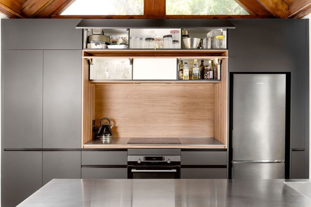 A kitchen with stainless steel appliances and a stainless steel refrigerator