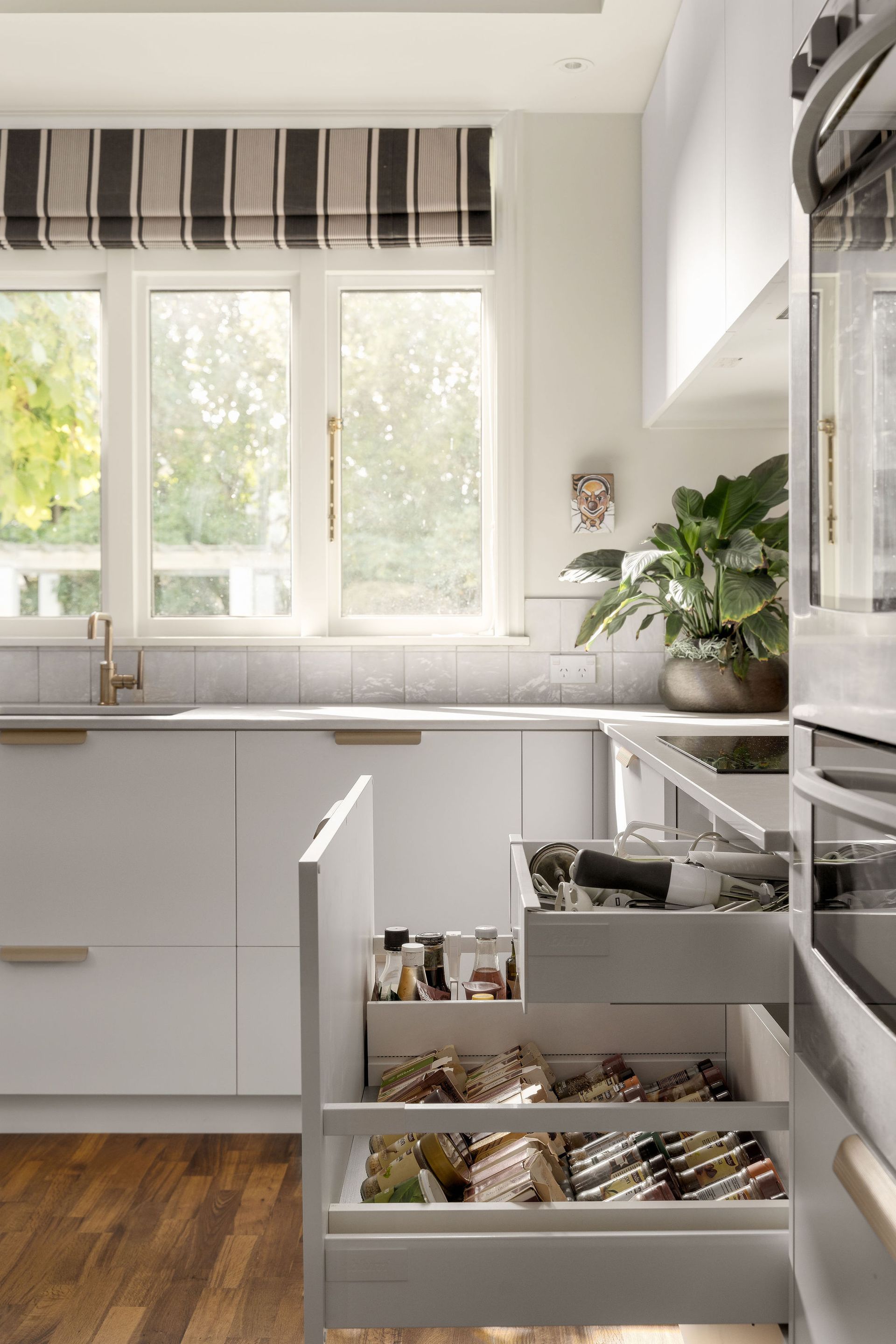 A kitchen with lots of drawers and a window.