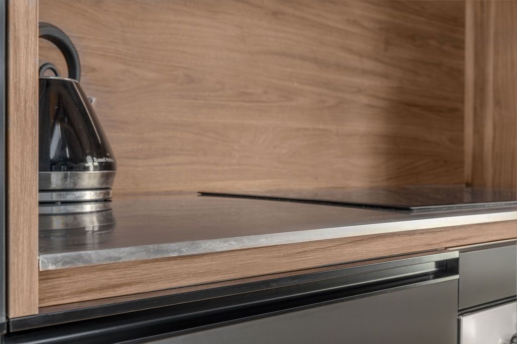 A close up of a kitchen counter with a kettle on it.
