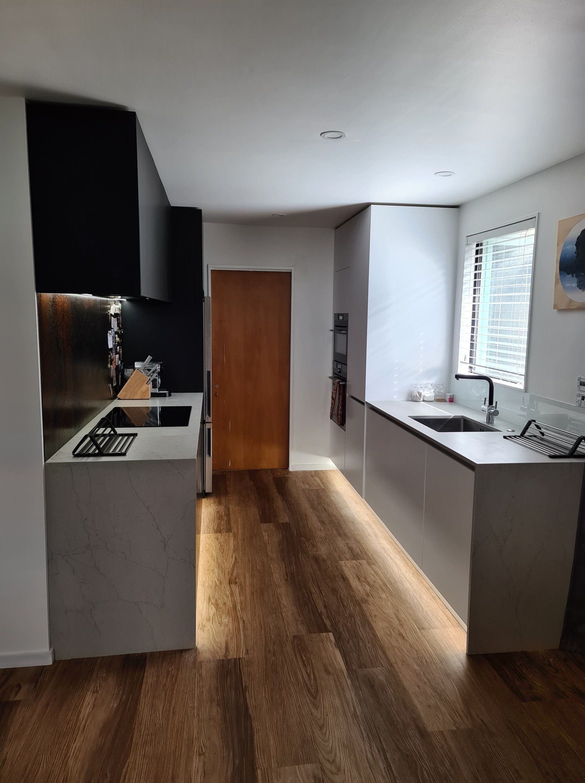 A kitchen with a sink , stove , and refrigerator.