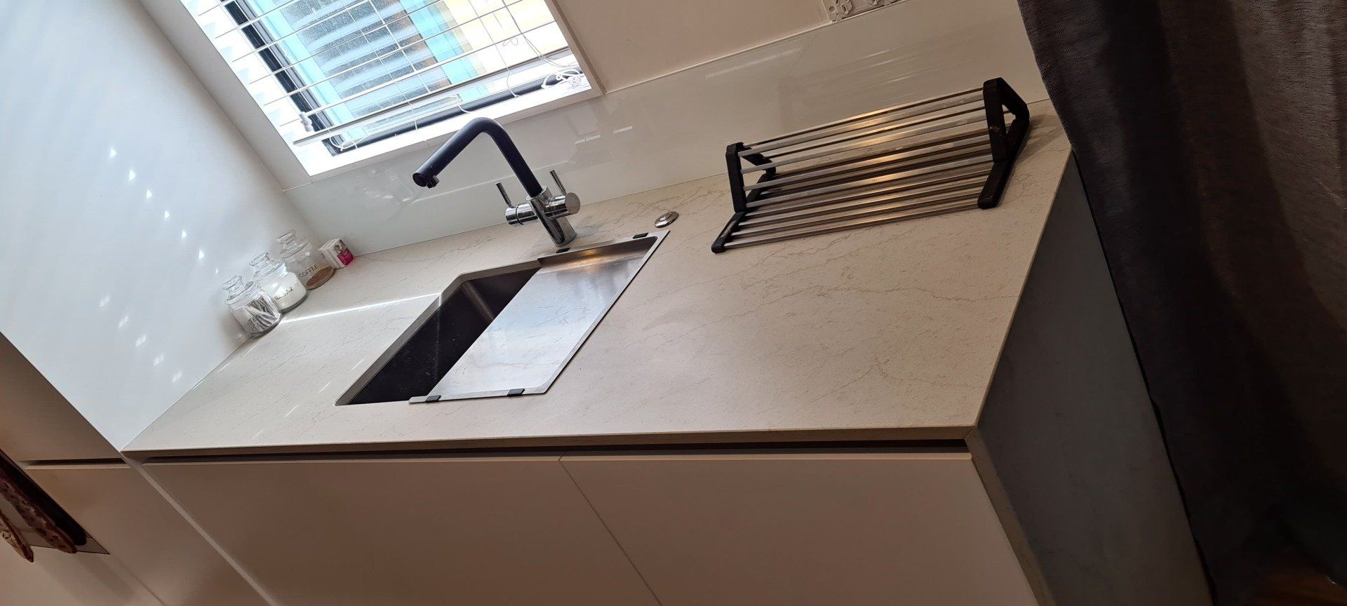 A kitchen counter with a sink and a window.