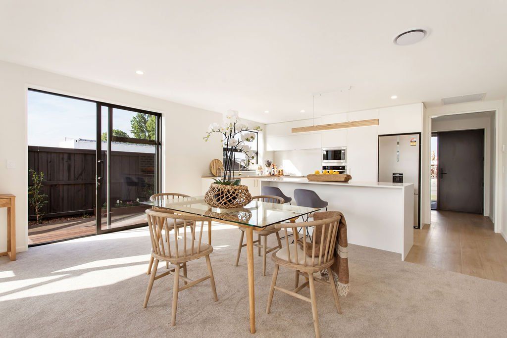 A dining room in a house with a table and chairs