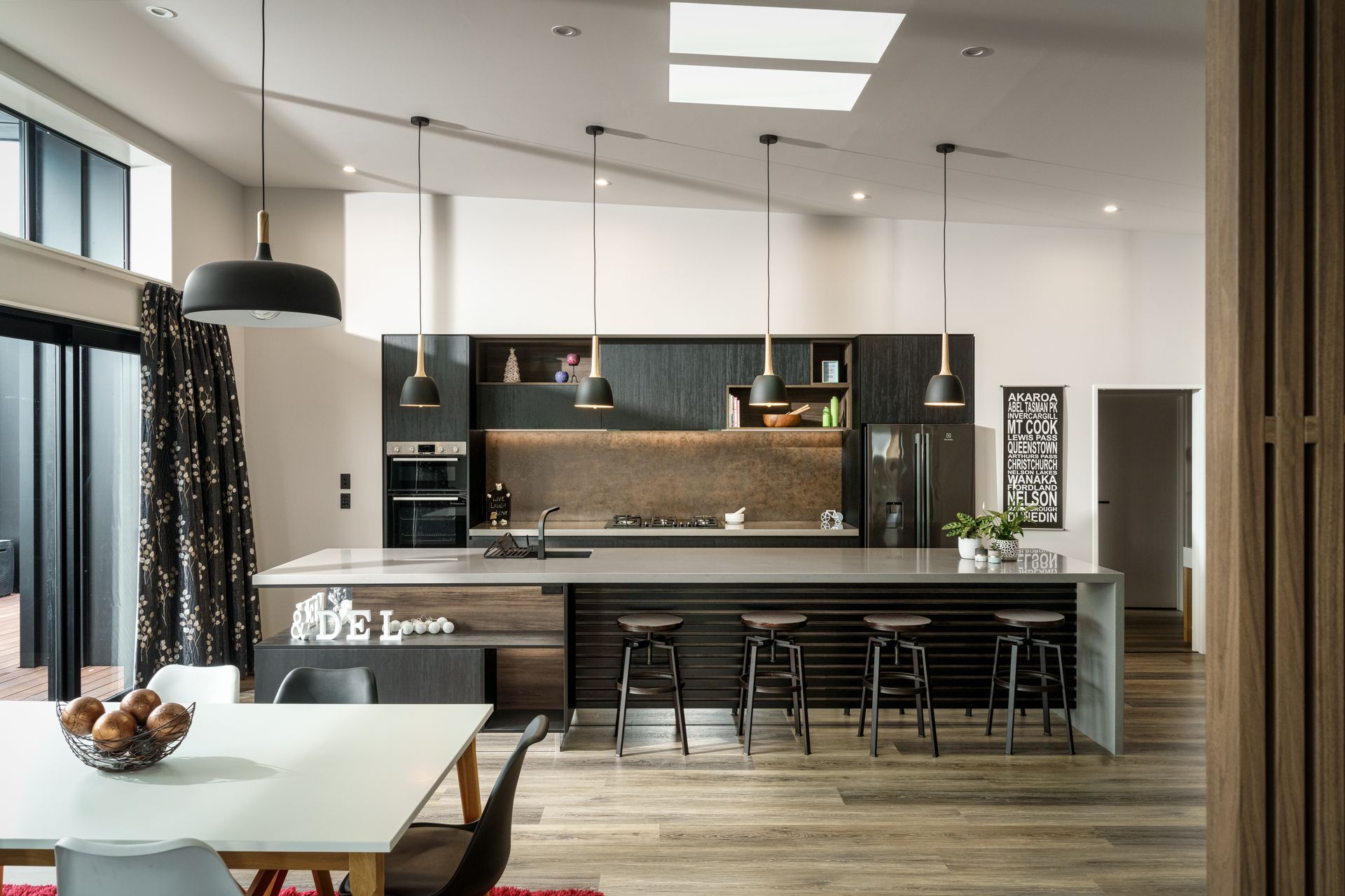 A kitchen with a large island and a dining table
