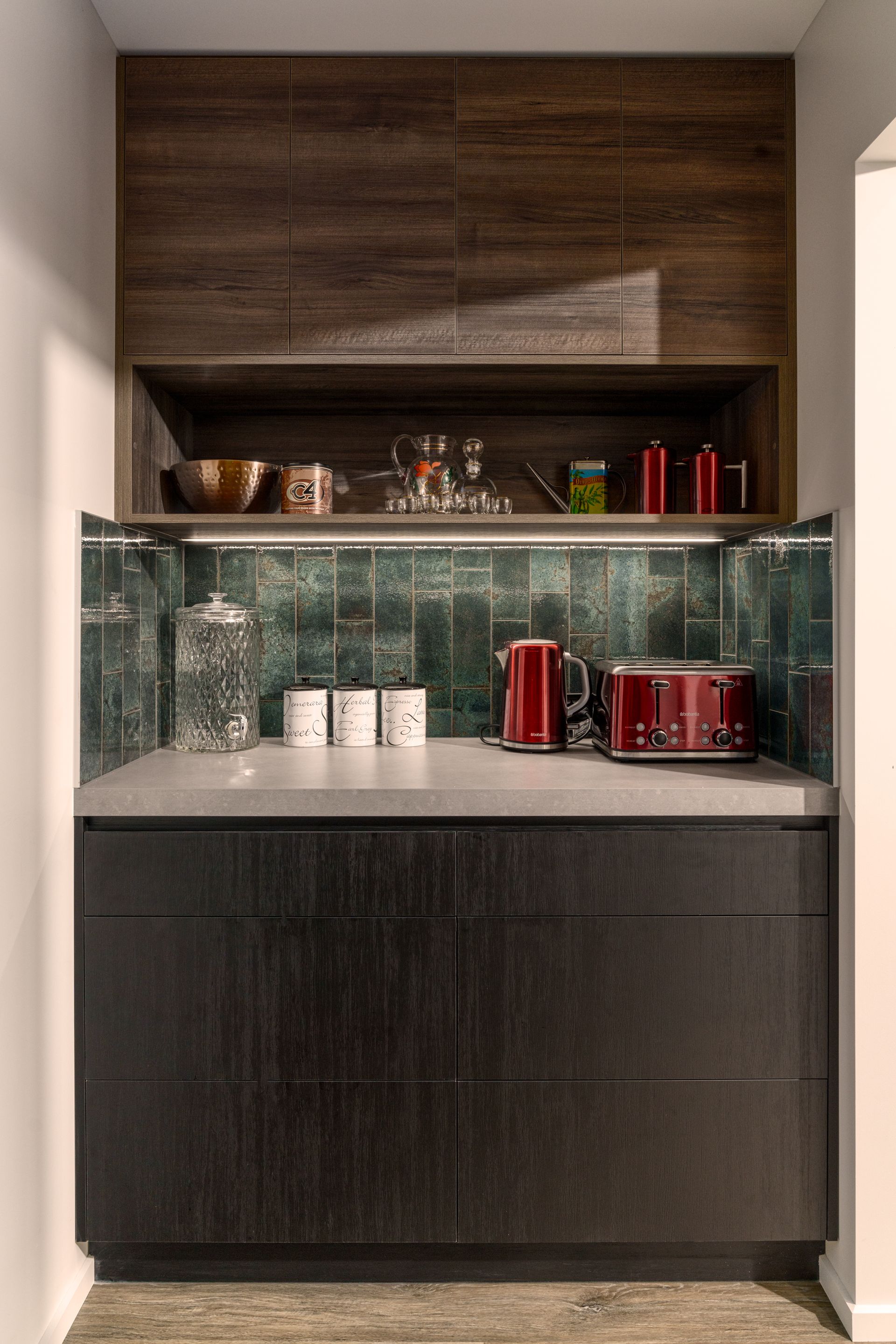 A kitchen with a counter top , cabinets , and a toaster oven.