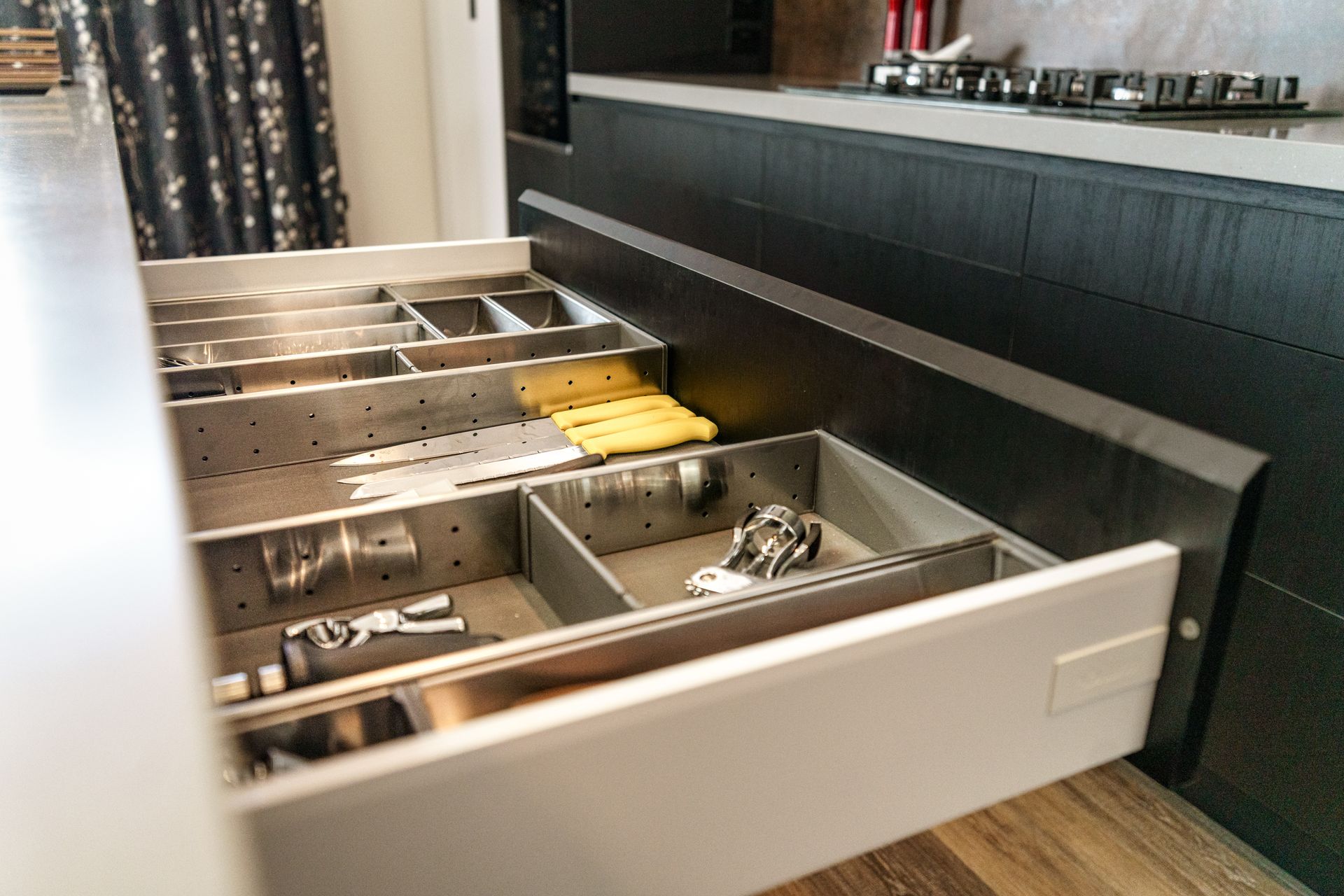 A kitchen drawer filled with silverware and utensils.