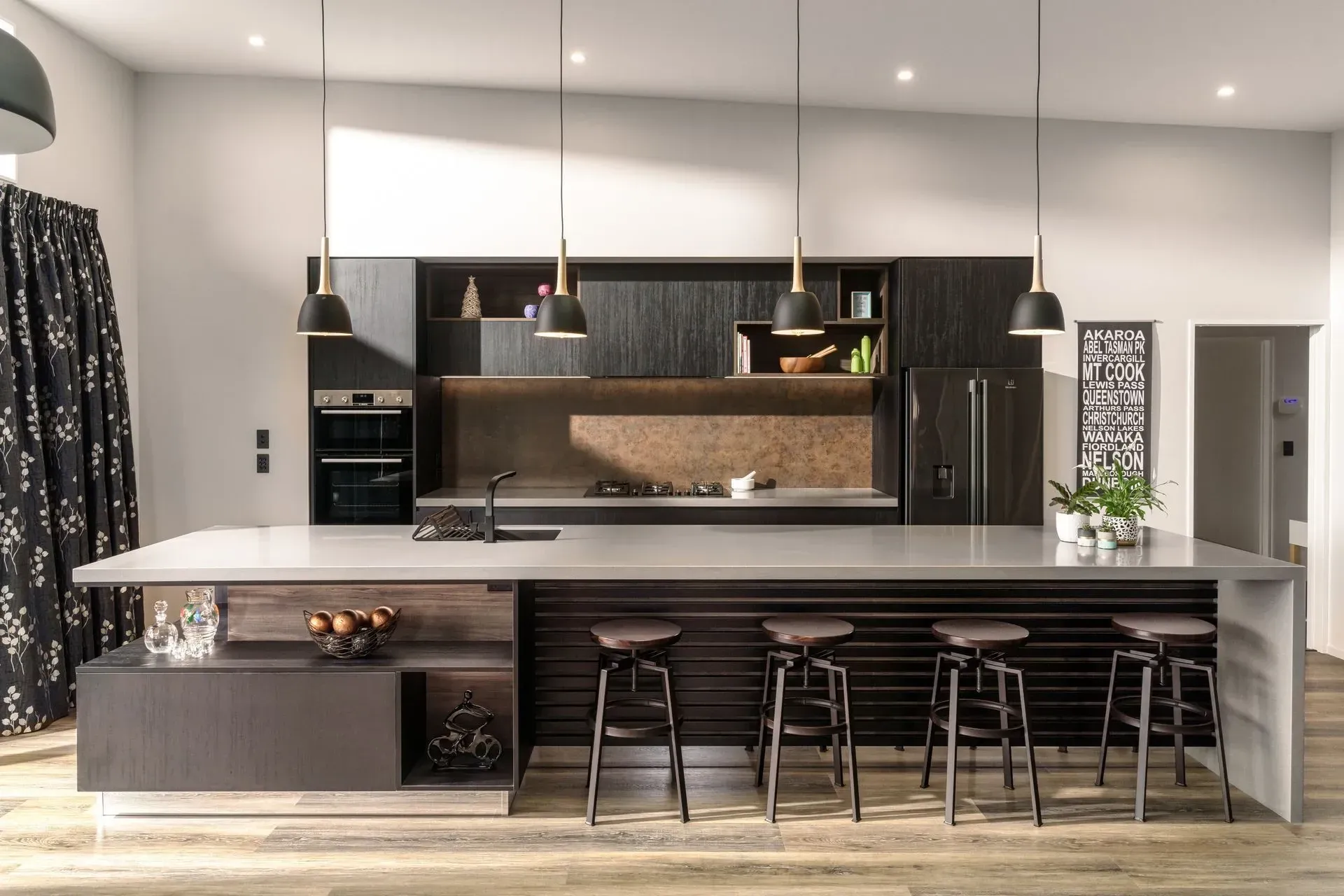 A kitchen with a large island and stools