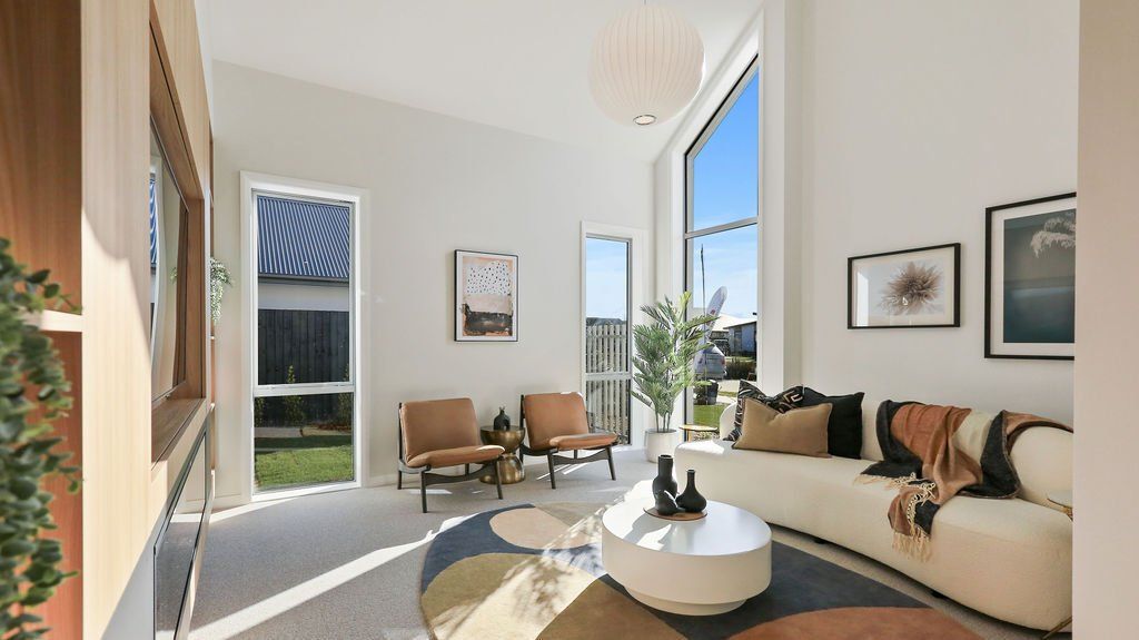 A living room with a couch , chairs , and a table.
