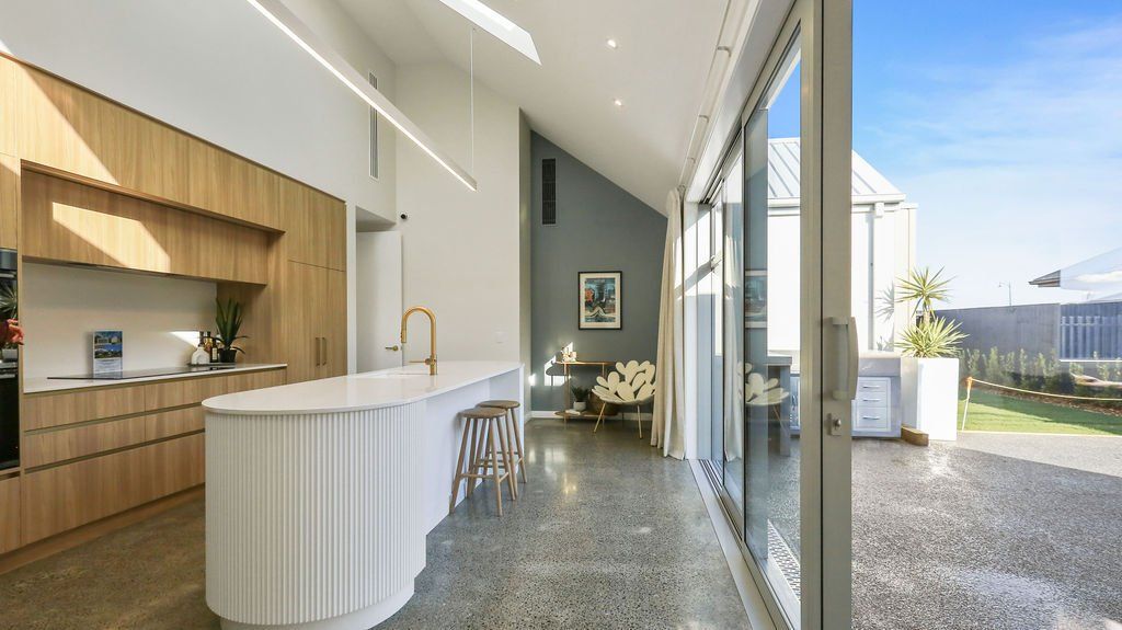 A kitchen with a large island and sliding glass doors.