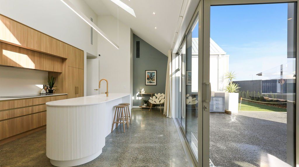 A kitchen with a large island and a sliding glass door.