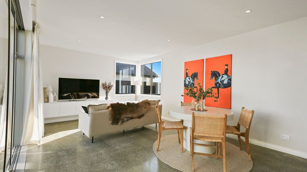 A living room with a couch a table and chairs