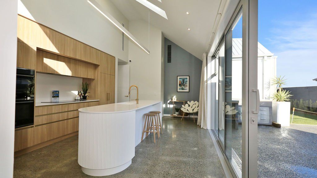 A kitchen with a large island and sliding glass doors