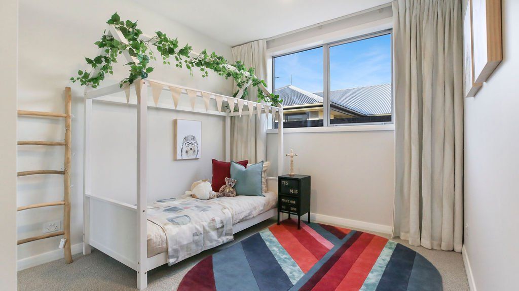 A bedroom with a bunk bed and a rug.