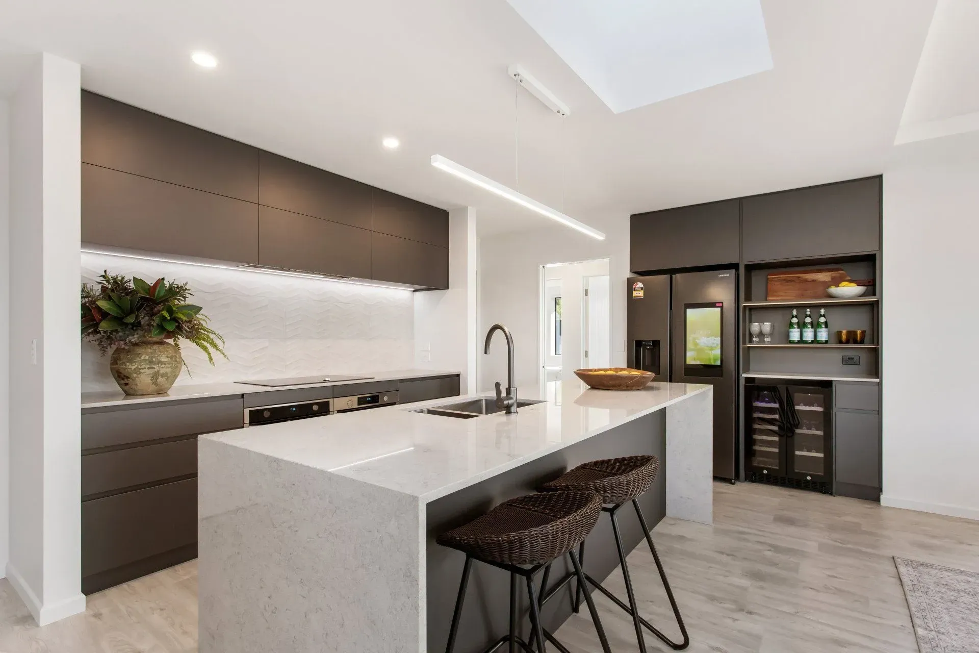 A kitchen with a large island and stools