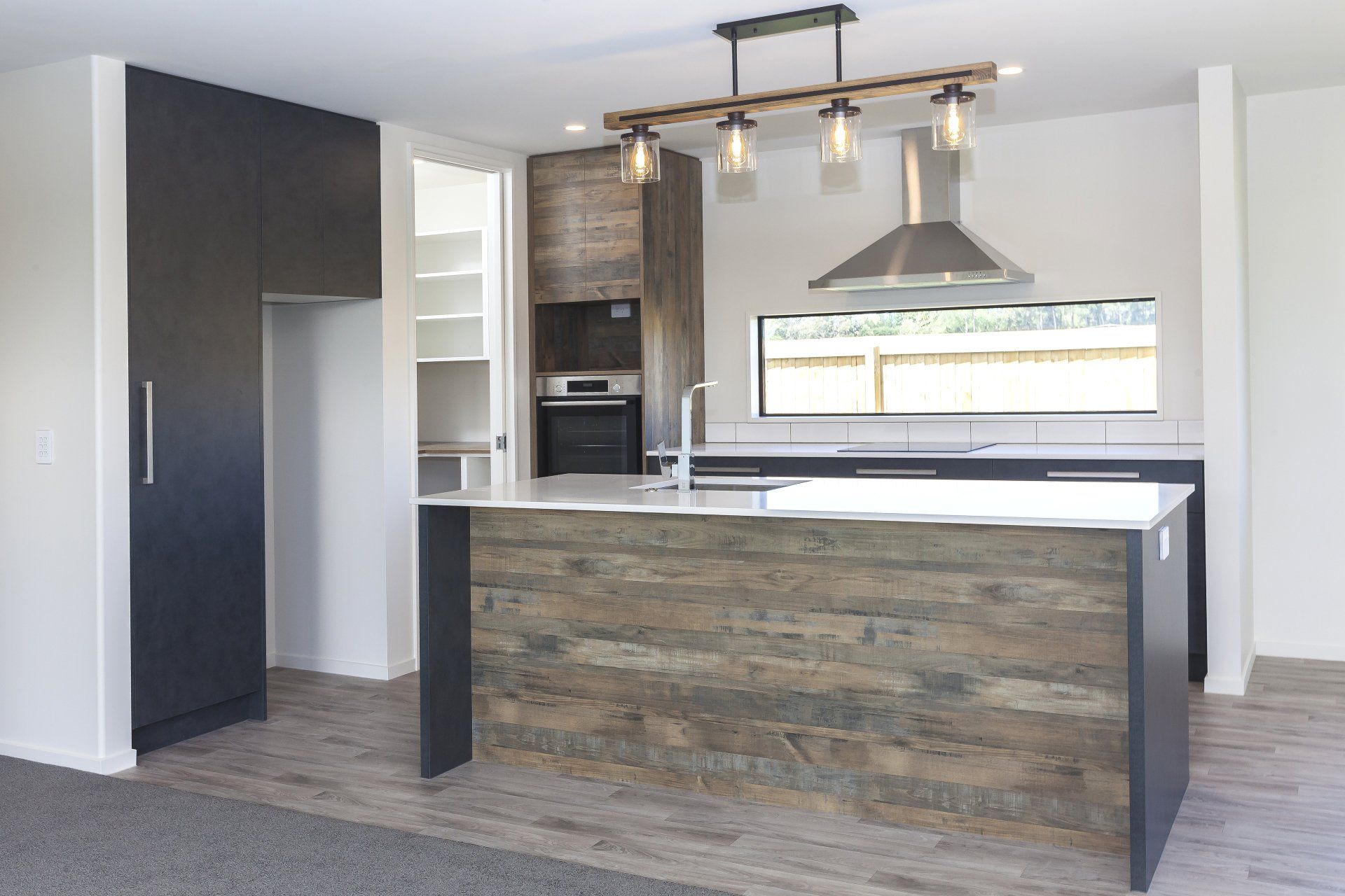 A kitchen with a large island in the middle
