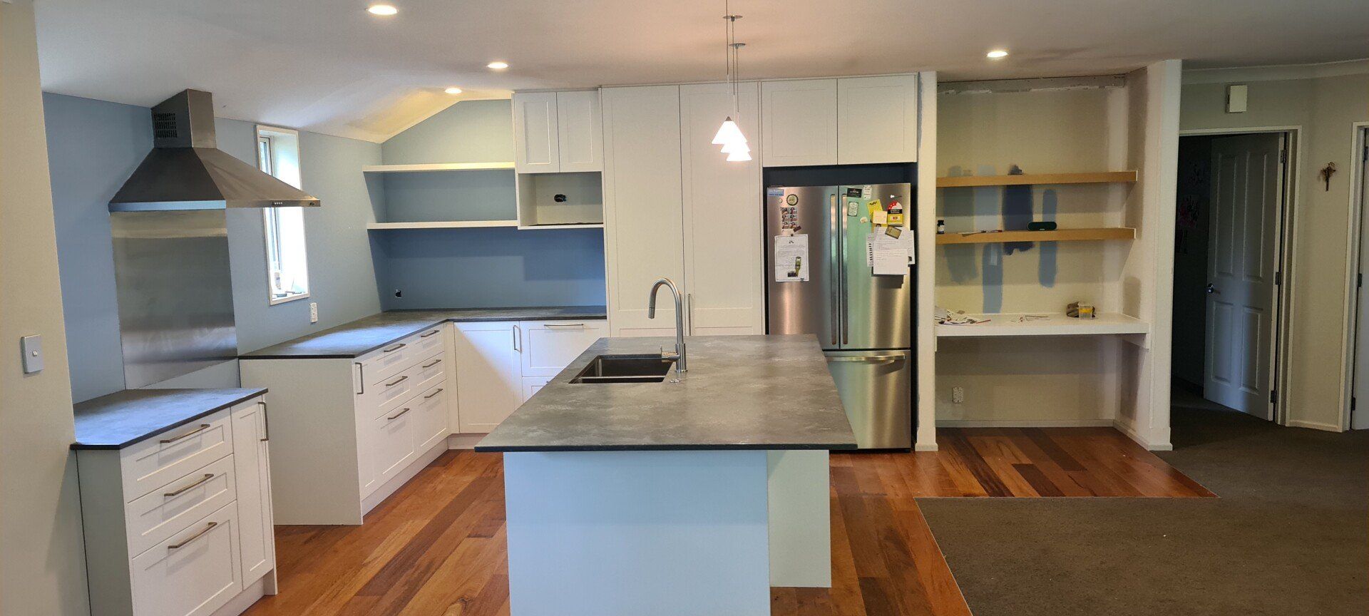 A kitchen with a large island in the middle of the room.
