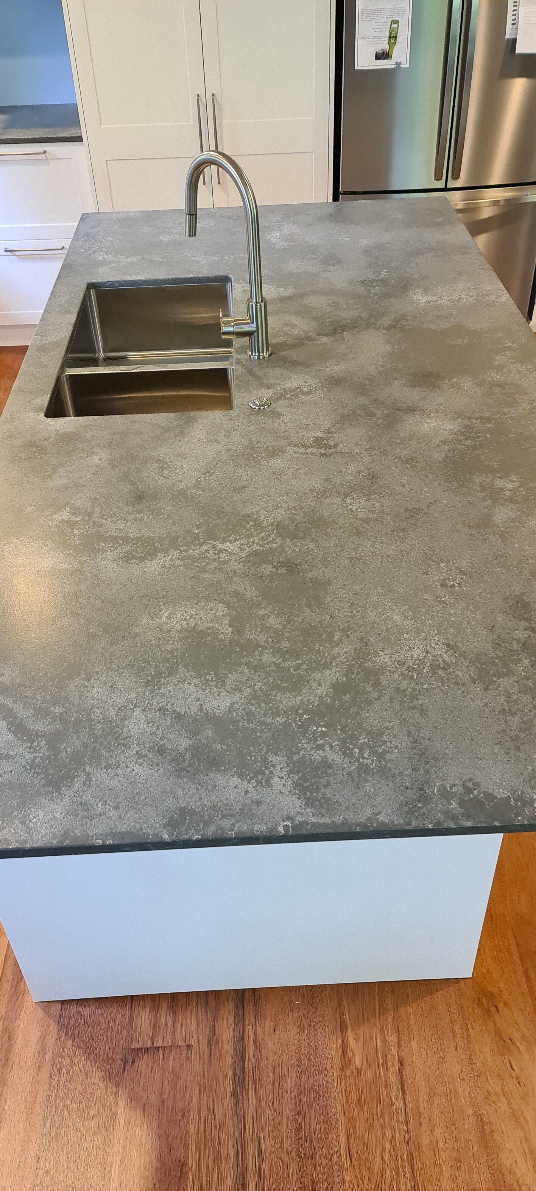 A kitchen counter with a sink and a faucet on it.