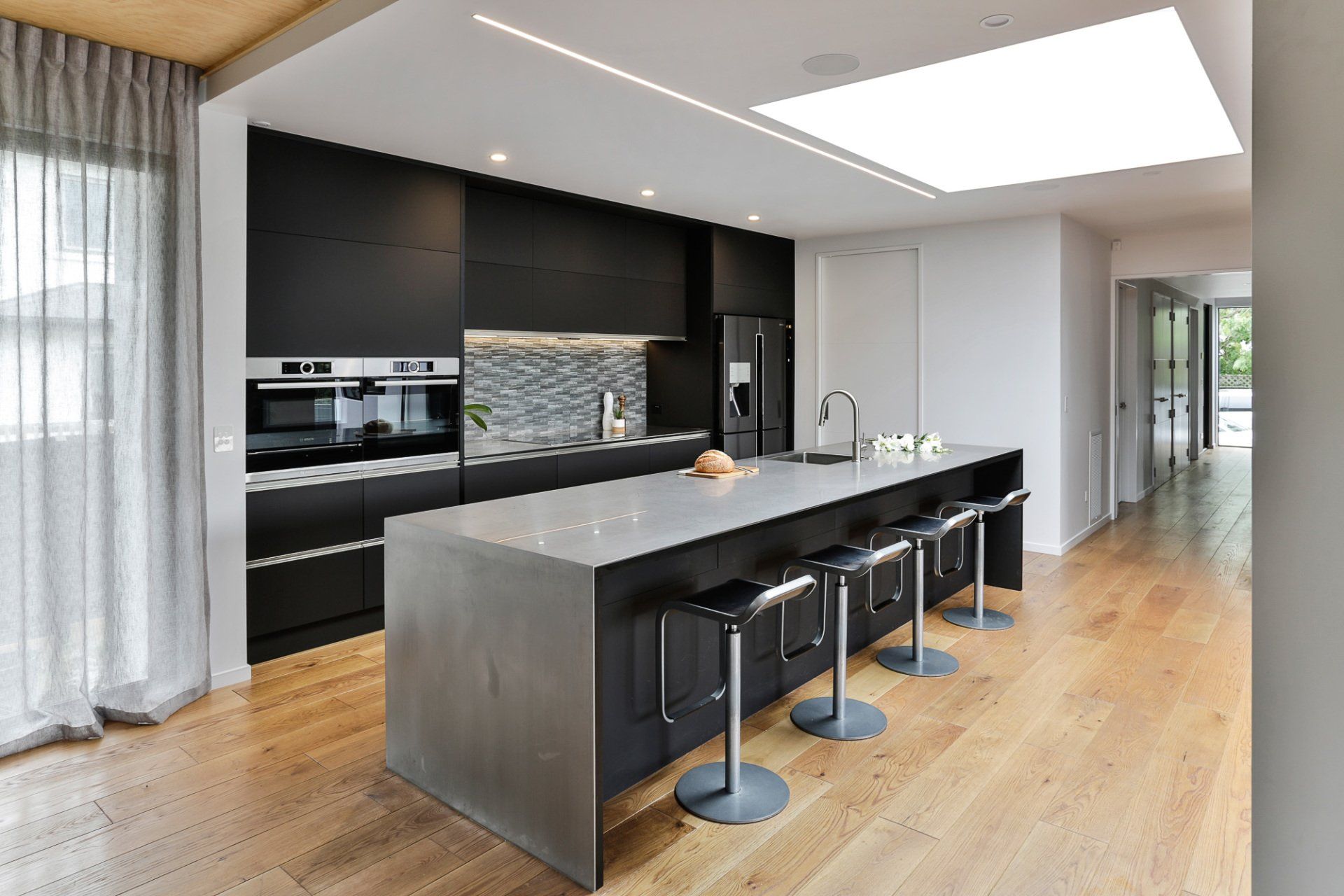 A kitchen with a large island and stools