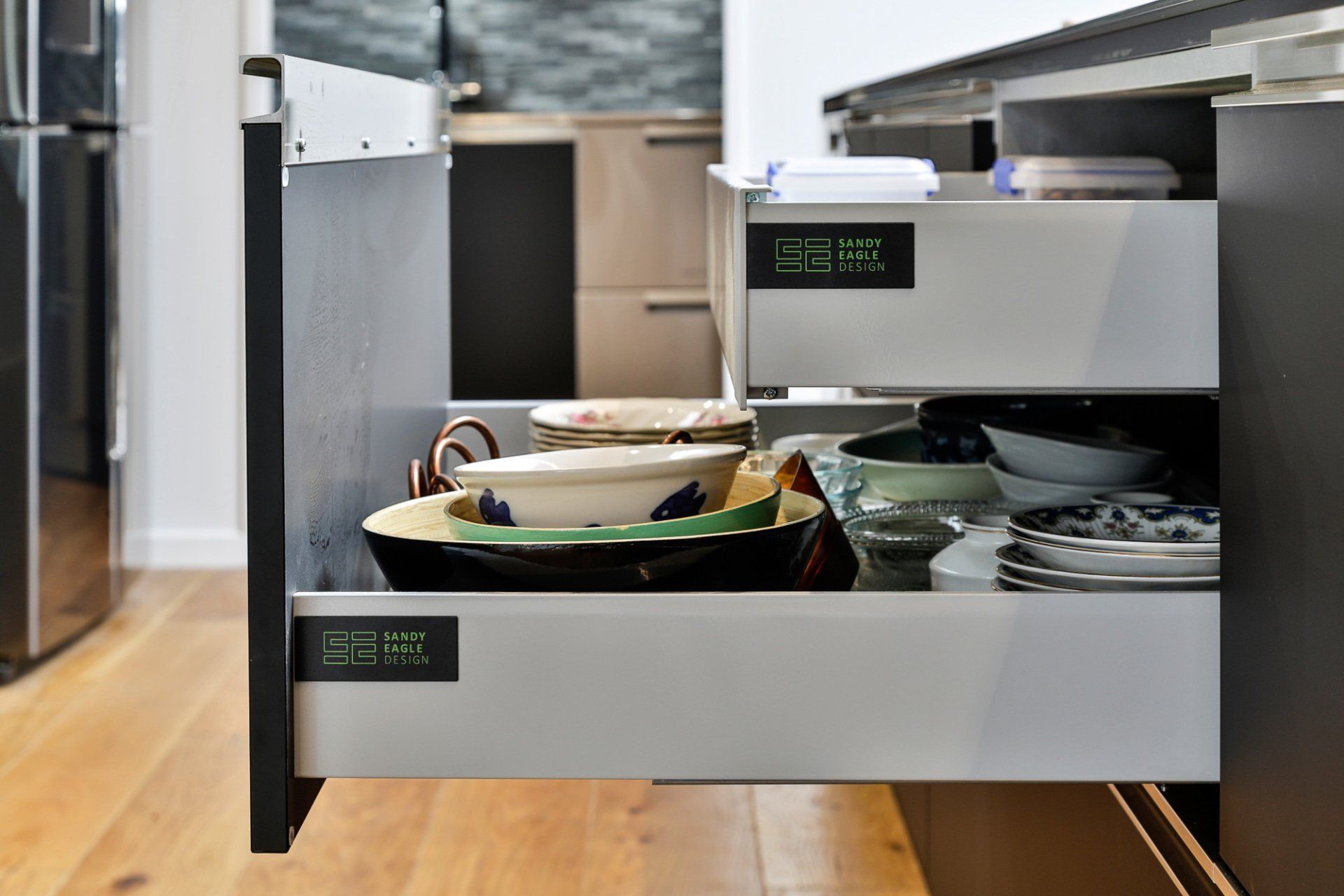 A kitchen drawer filled with bowls and plates.