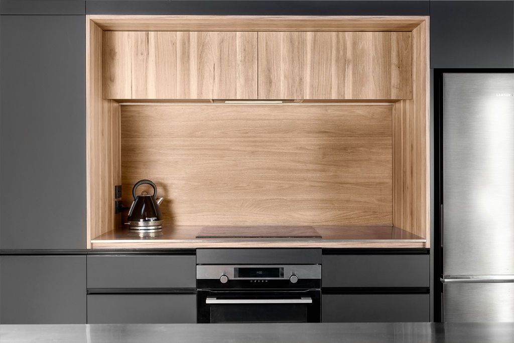 A kitchen with stainless steel appliances and wooden cabinets.