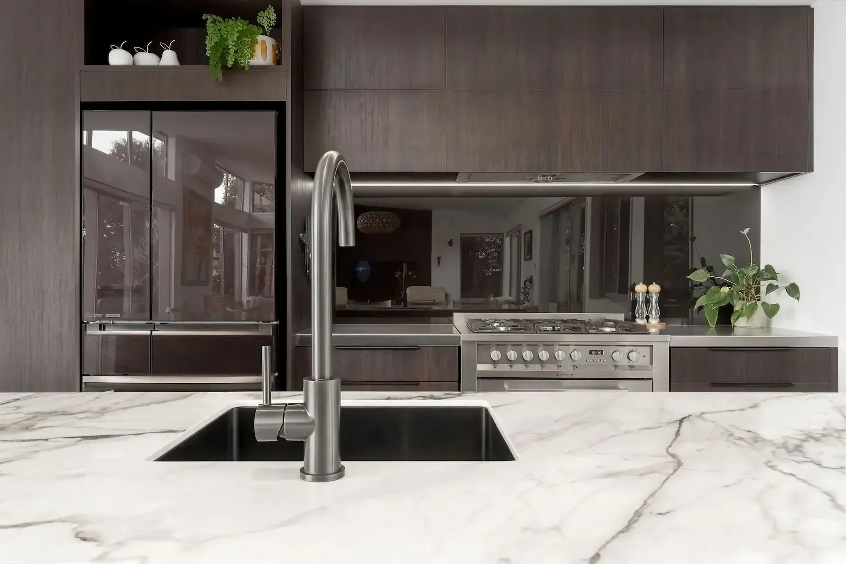 A kitchen with a sink , stove and refrigerator