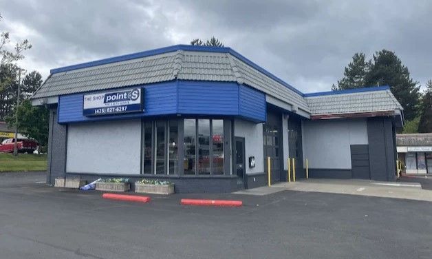 A blue and white building with a sign that says ' polaris ' on it | TIRE NATION & AUTO REPAIR POINT S