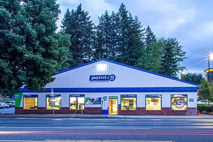 A white and blue building with the word point on it | TIRE NATION & AUTO REPAIR POINT S