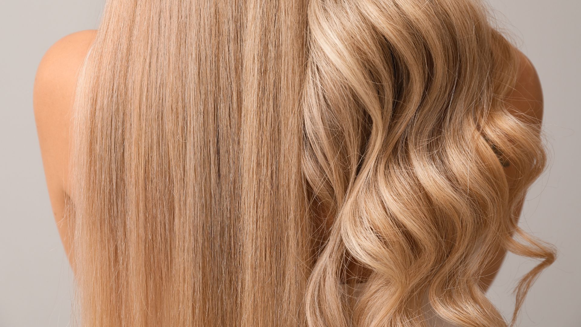 Woman with blonde hair, half straight and half curled, against a gray backdrop.