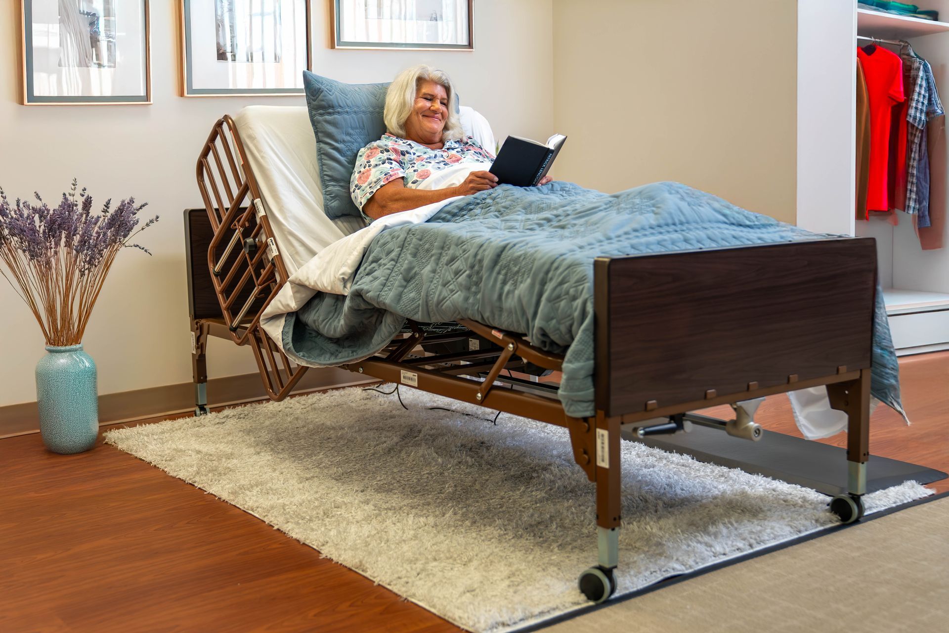 Hospital room with an empty bed, monitor, medical equipment, and a window.