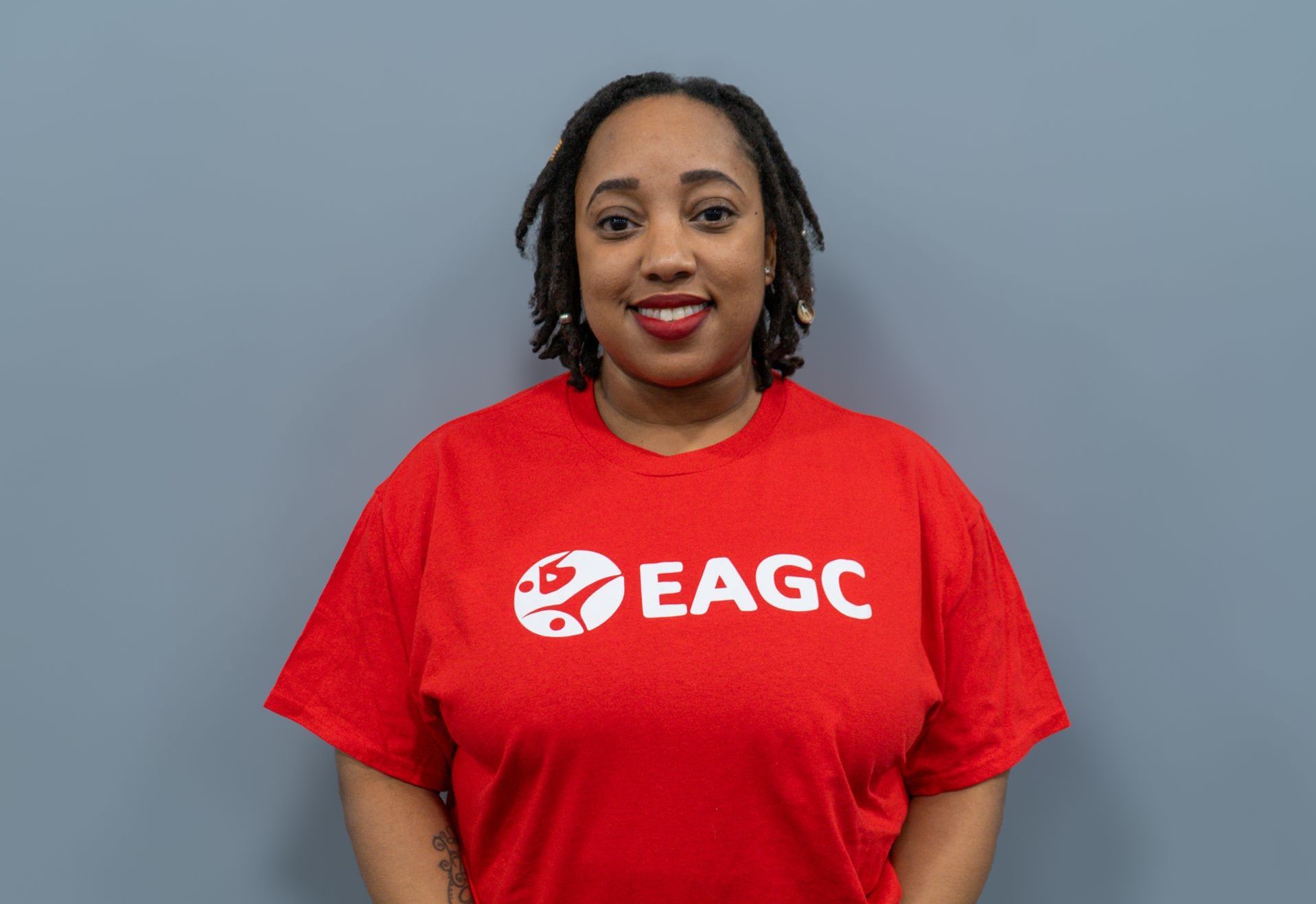 A Female Rec Coach wearing a red EAGC Tshirt