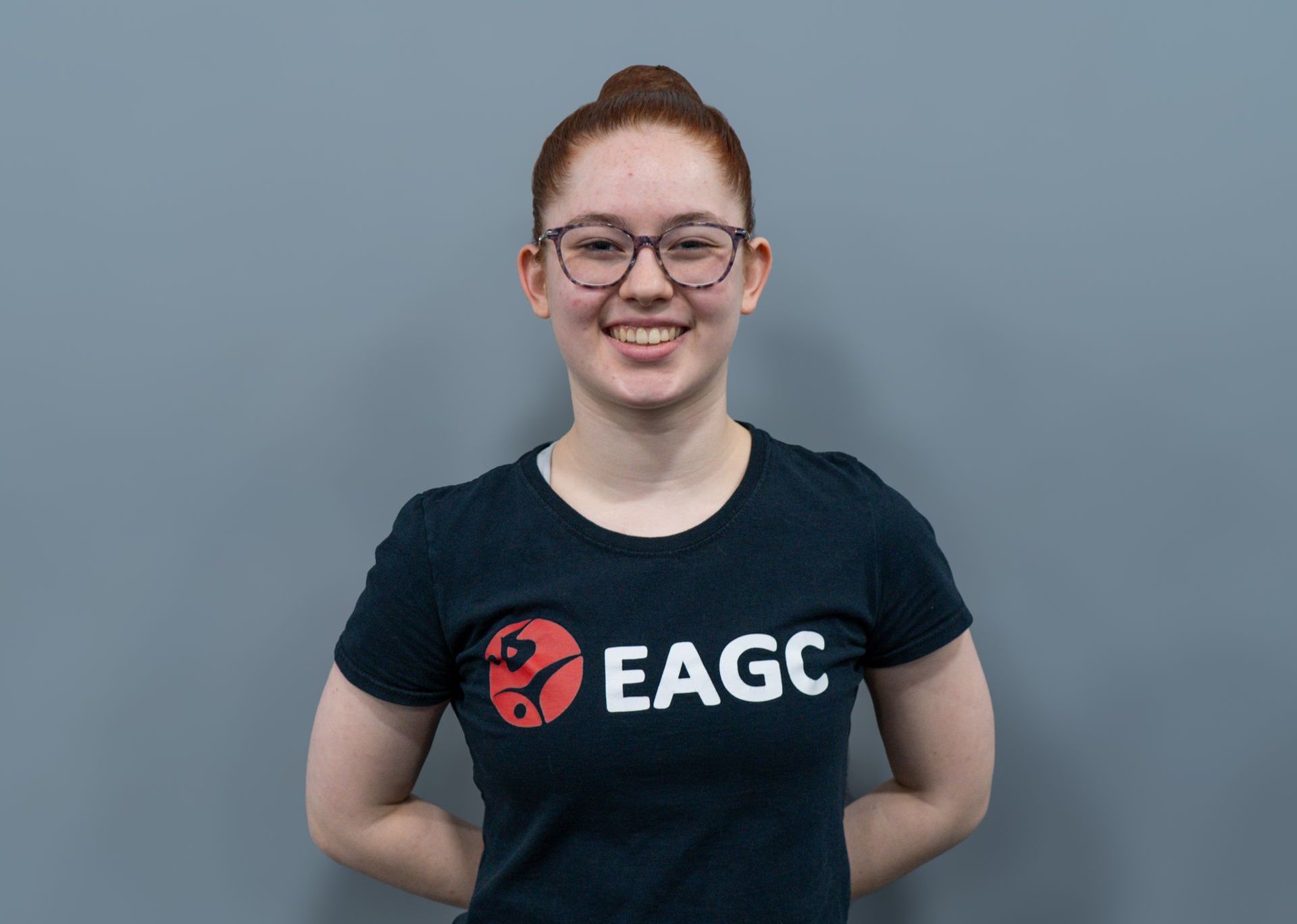 A Female Rec Coach wearing a black EAGC Tshirt