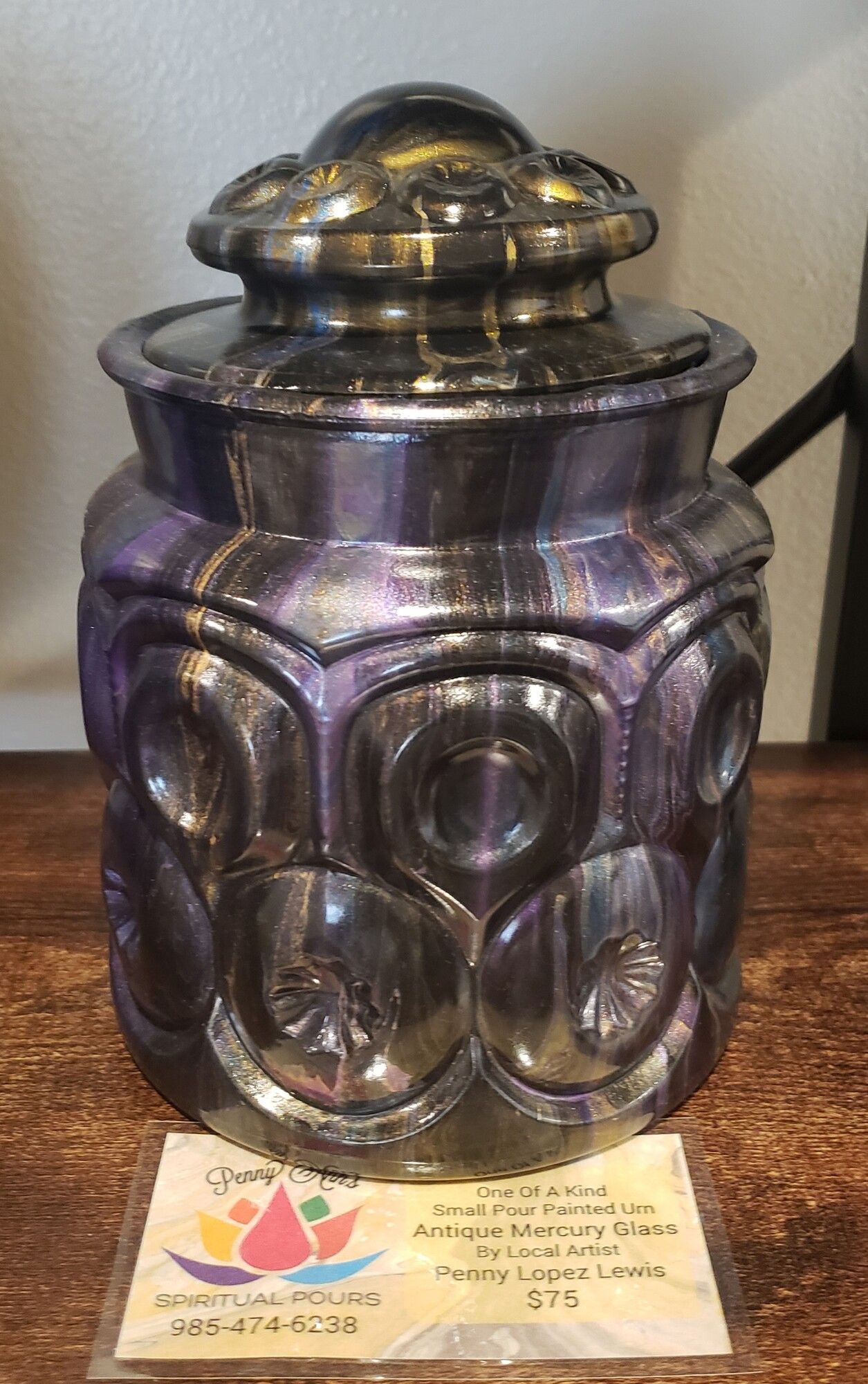 Purple and silver decorative jar with a lid.