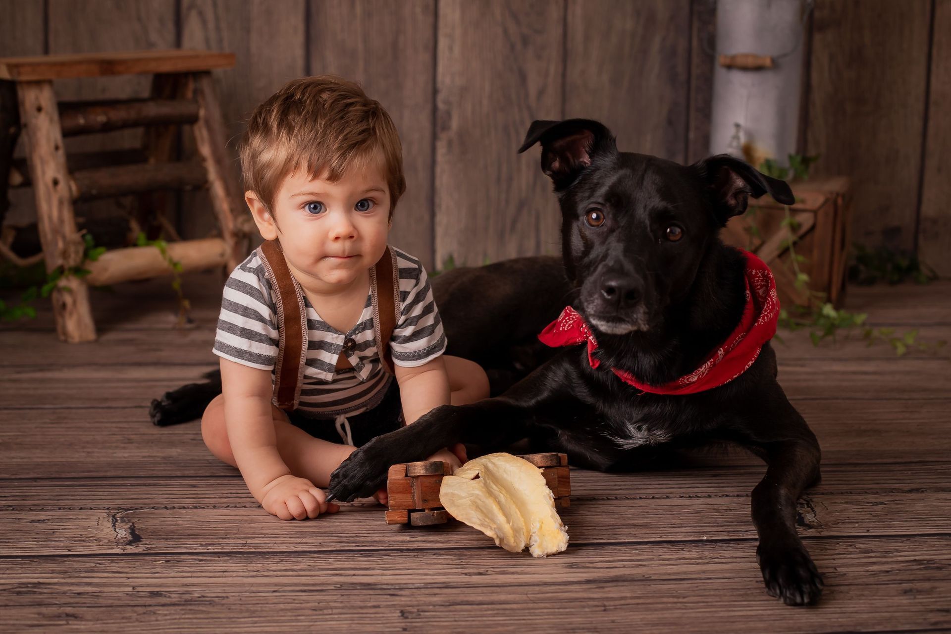 Un bebé gatea sobre un suelo de madera y lleva un sombrero marrón.