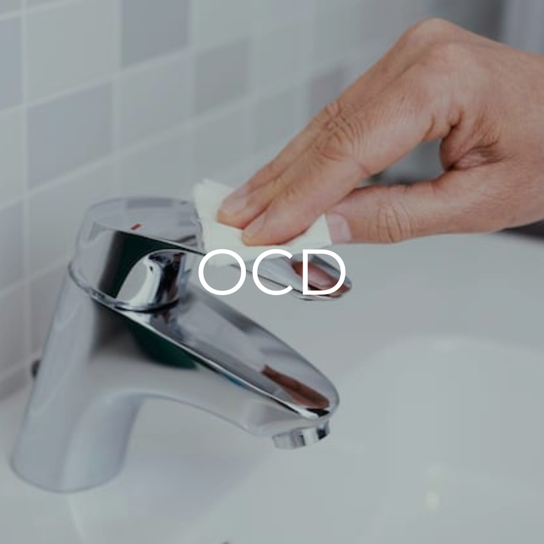A person is cleaning a bathroom sink faucet with a cloth
