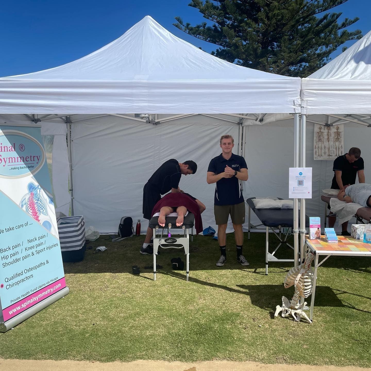 A Man Is Getting A Massage Under A White Tent — Spinal Symmetry In Port Stephens, NSW