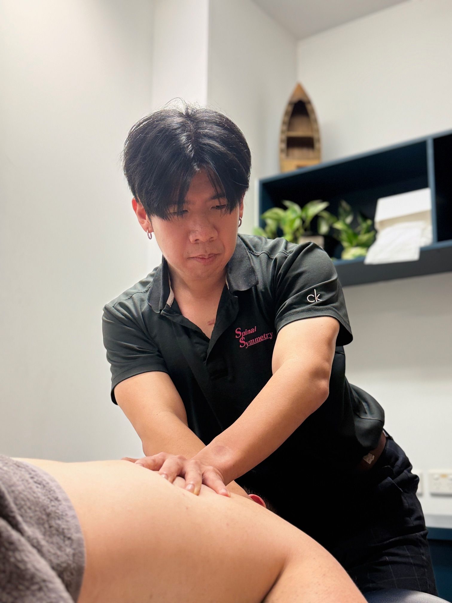 A practitioner doing a back massage— Spinal Symmetry In Salamander Bay, NSW