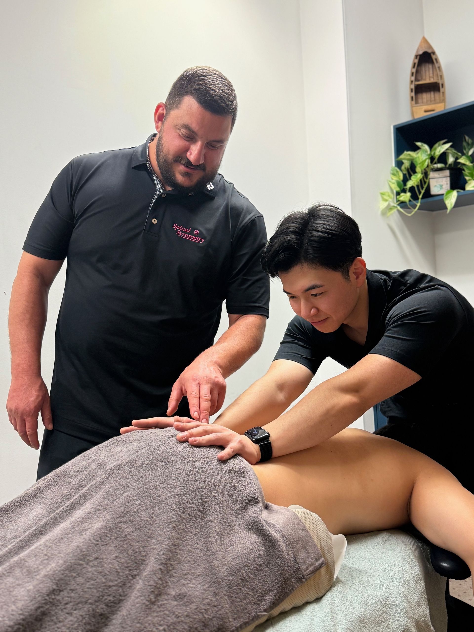 A Man  Is Getting A Massage From A Chiropractic practitioner  — Spinal Symmetry In Salamander Bay, NSW