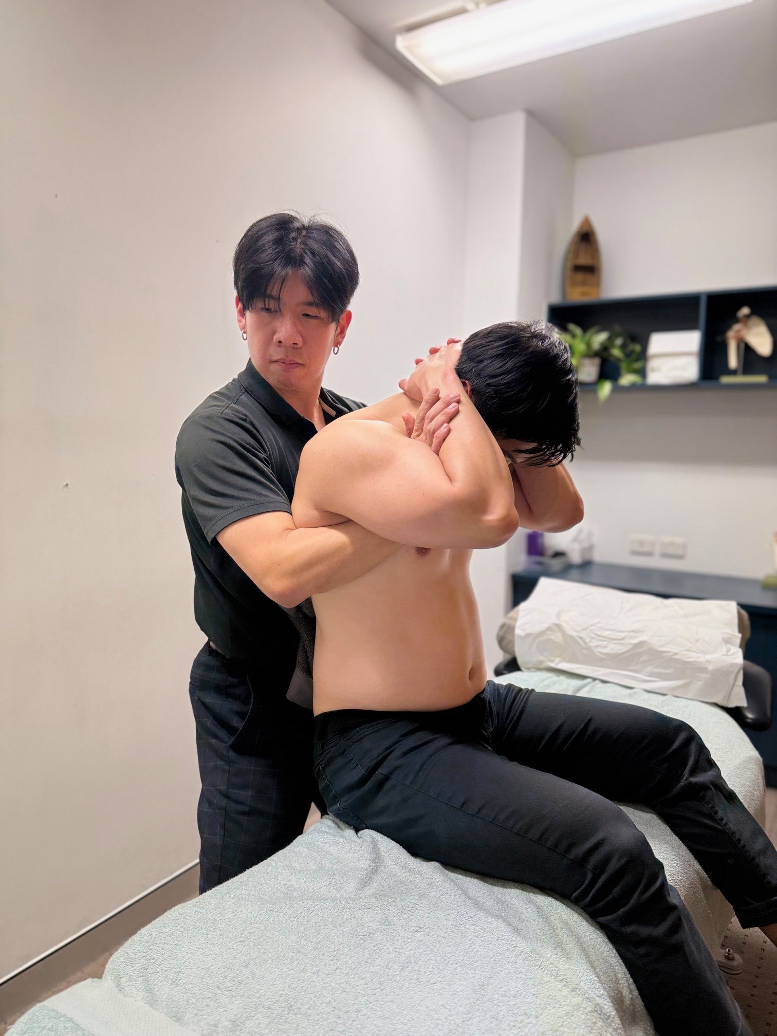 Man in Black Shirt Adjusting Another Man's Back — Spinal Symmetry In Port Stephens, NSW