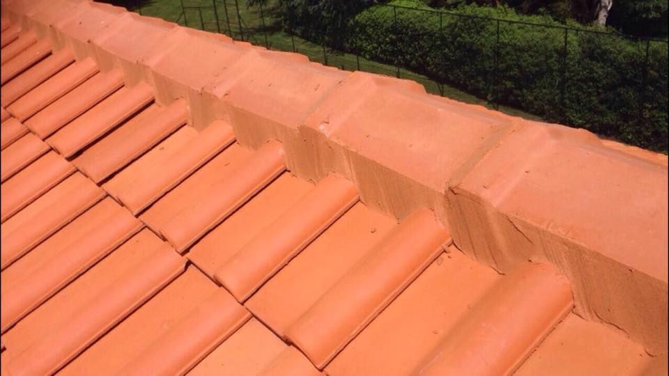 A roof with a lot of red tiles on it