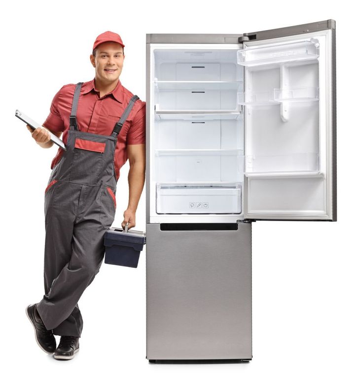 a man standing next to an empty refrigerator with the door open