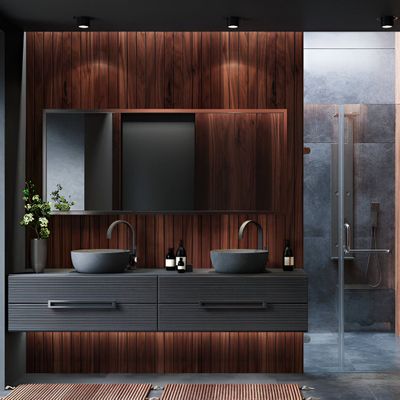 Modern bathroom with dark wood paneling, dual sinks, large mirror, and glass shower.