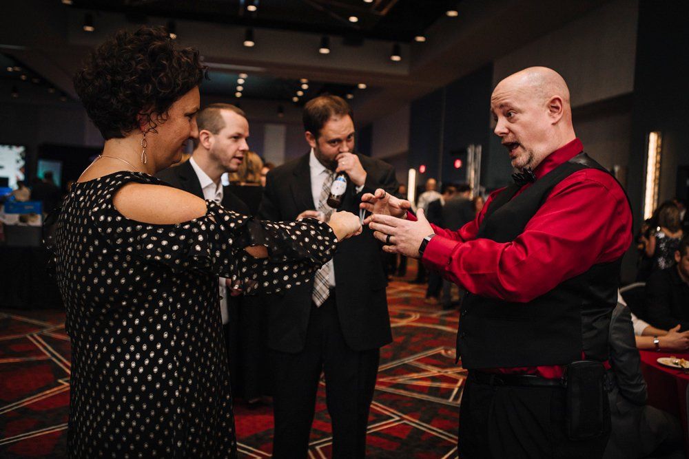 Corporate magic entertainer Matt Redlaw standing with three people