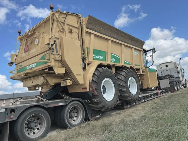 Tow operator preparing heavy duty equipment for truck recovery