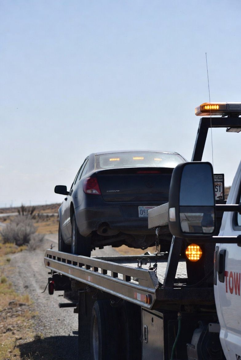 Emergency roadside assistance vehicle parked beside stalled car