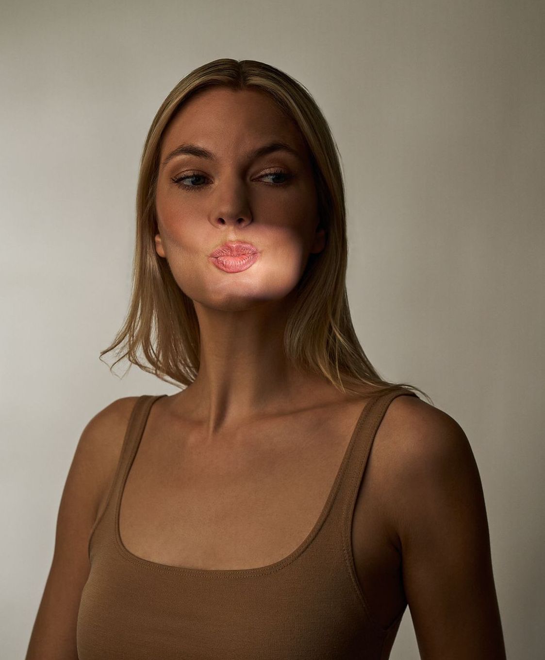 Nahaufnahme einer Frau mit langen Haaren und rosa Lippen LIP FLIP. Muskelrelaxans